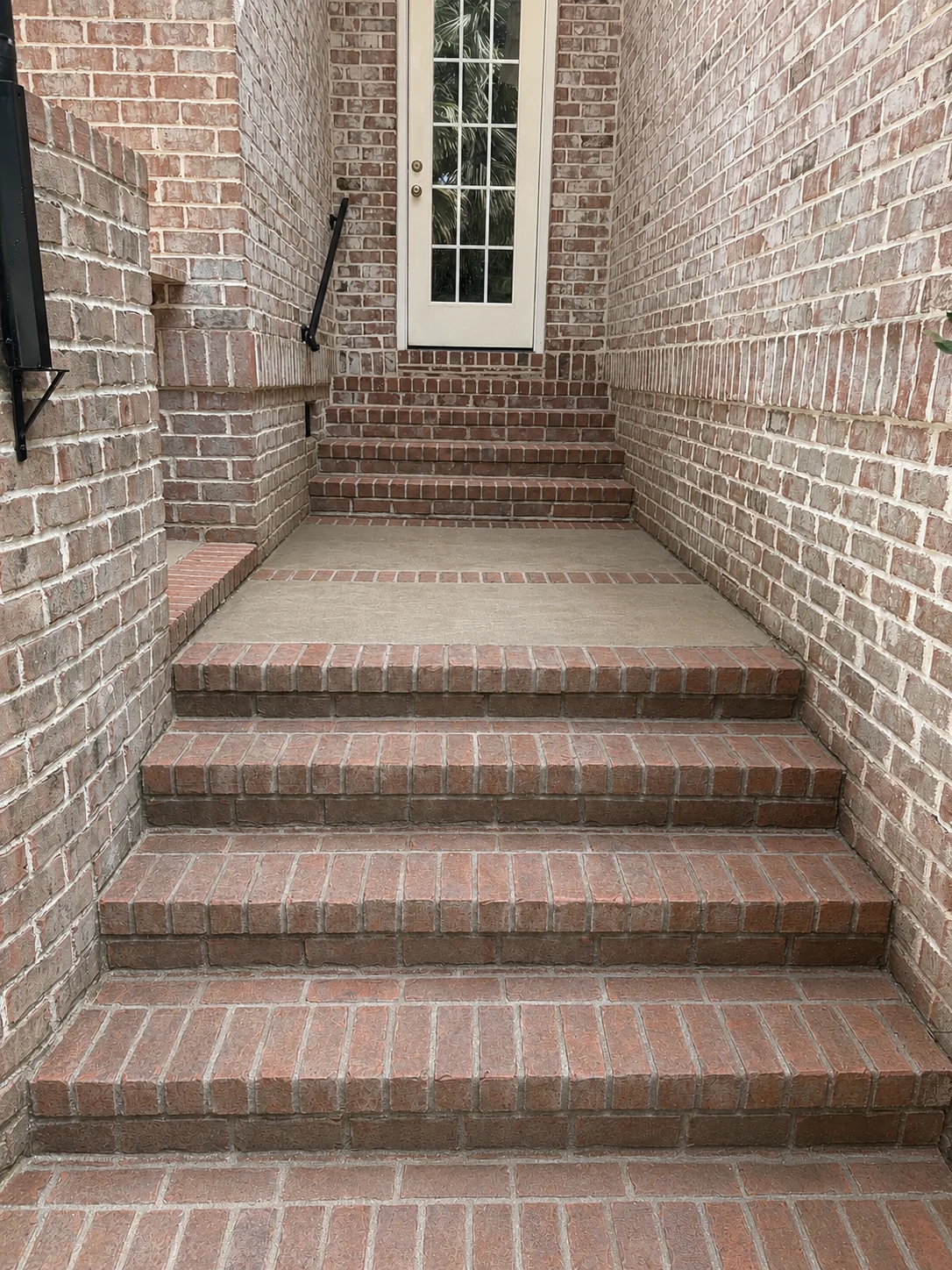 Brick front steps and sheltered entry after cleaning