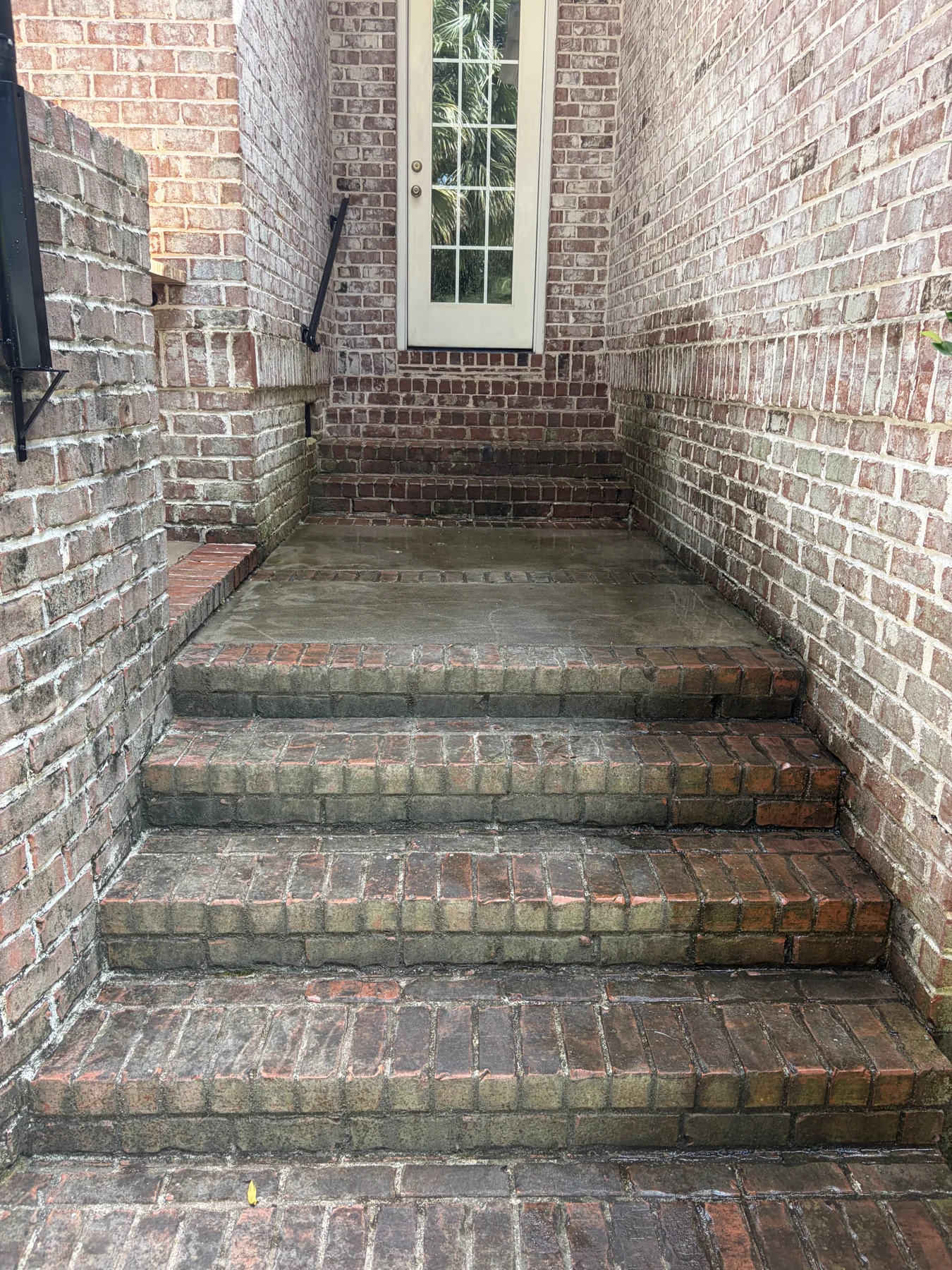 brick front steps and entry before cleaning