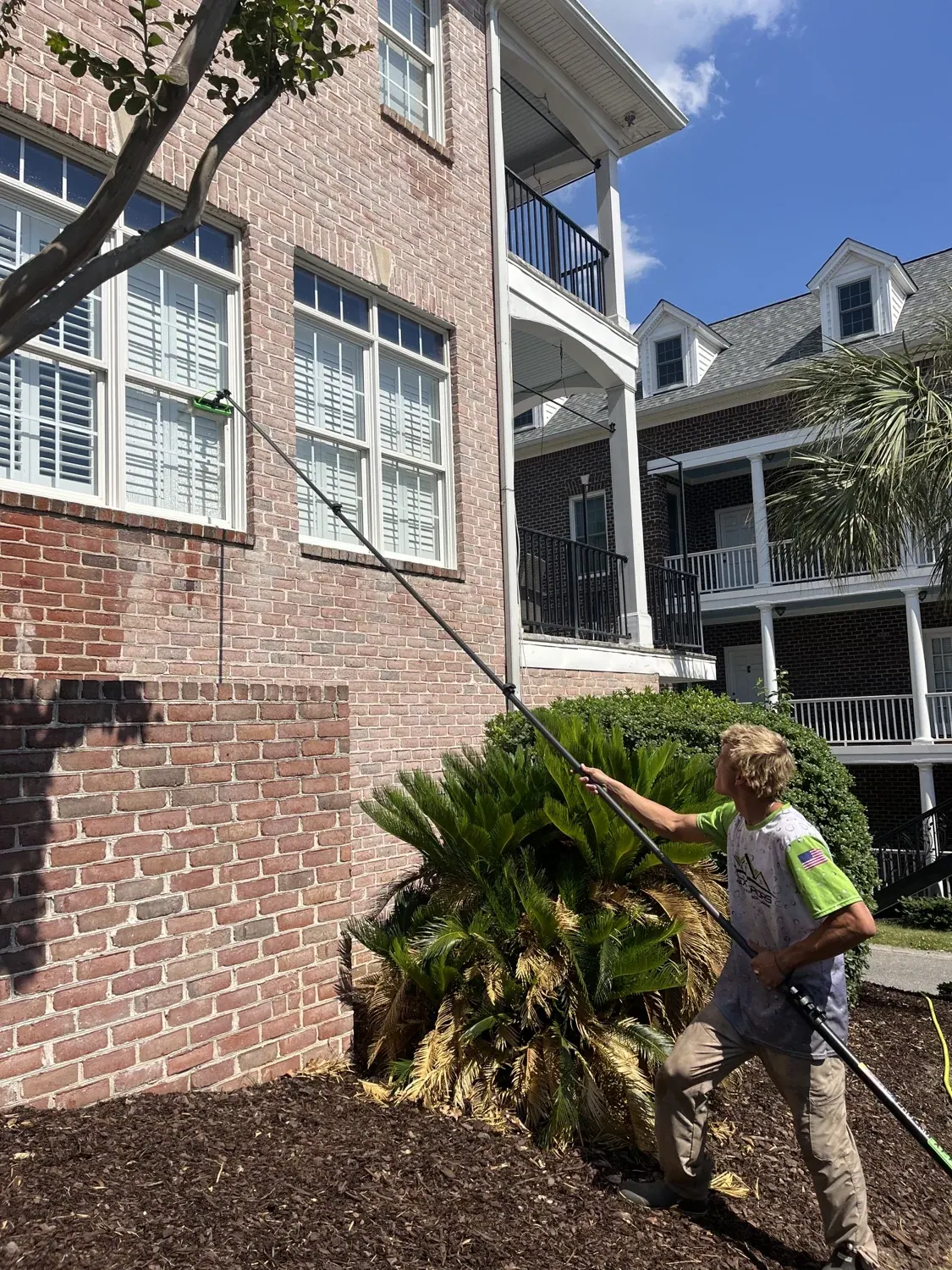 Andrew using a water-fed pole for exterior window cleaning